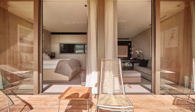 balcony with lounge chairs and a view into the bedroom in the black forest
