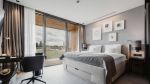 Light-flooded room with a spacious double bed and a work area equipped with a dark table