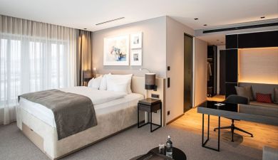 view into the junior suite with a comfy bed and an open living and working area
