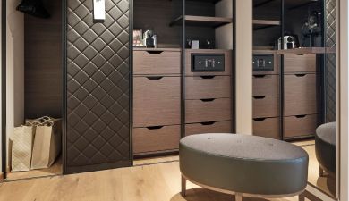 elegant dark wood closet with a coffee machine and a safe