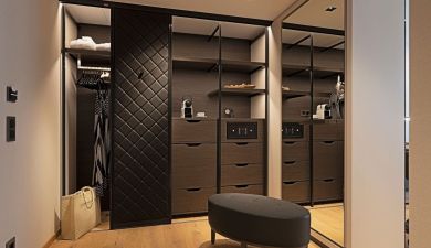 dressing room with a dark wood closet and a big mirror