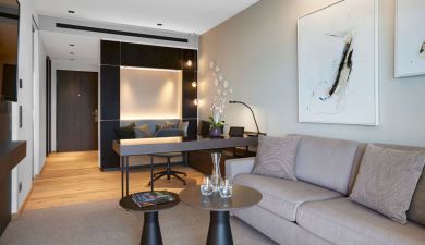 living area with a working niche and framed abstract paintings on the walls