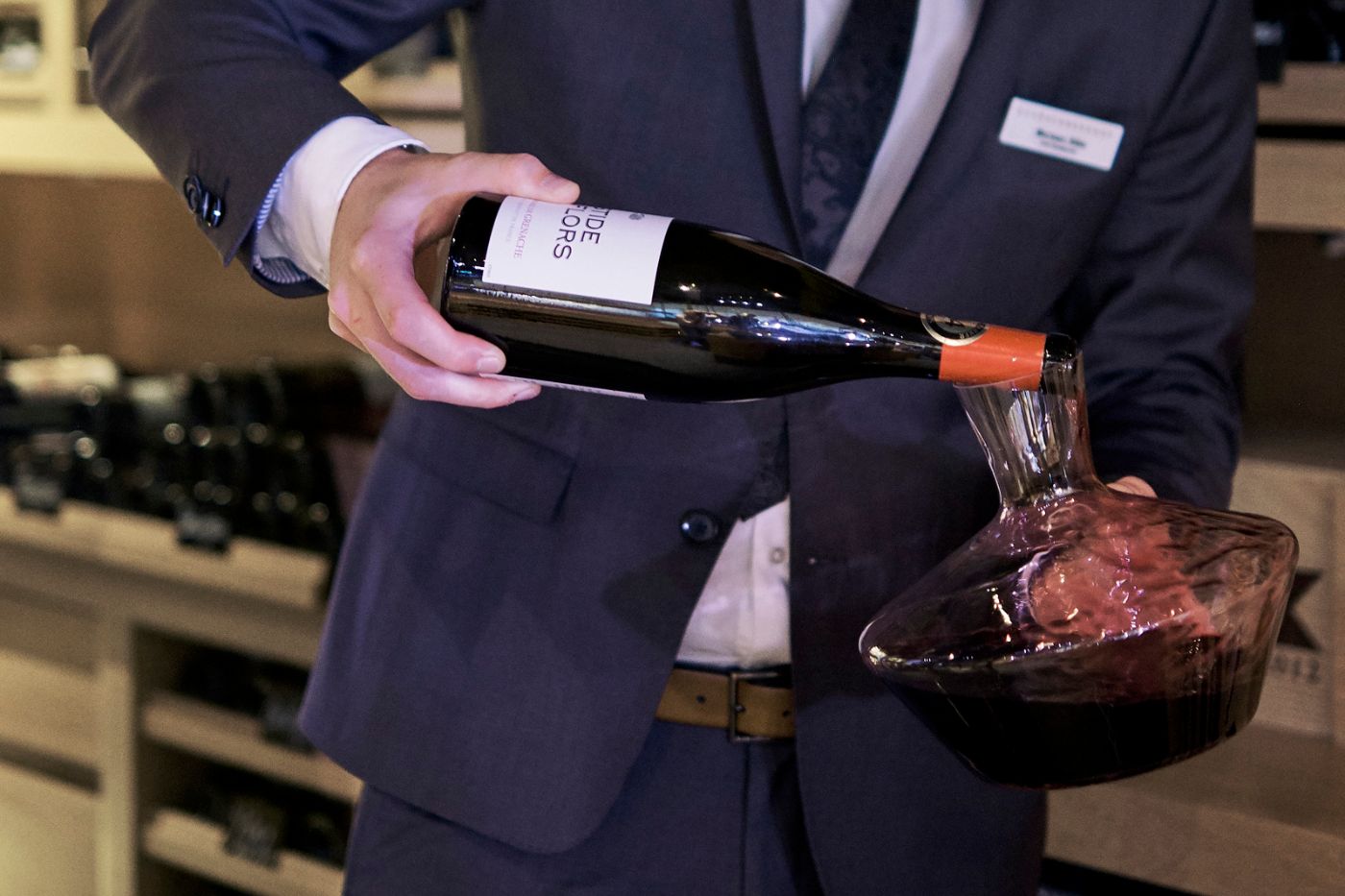 Sommelier pours wine from a carafe in a star restaurant in the black forest